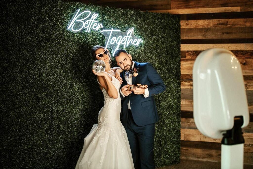 A bride and groom posing for the photo in our Photo Booth