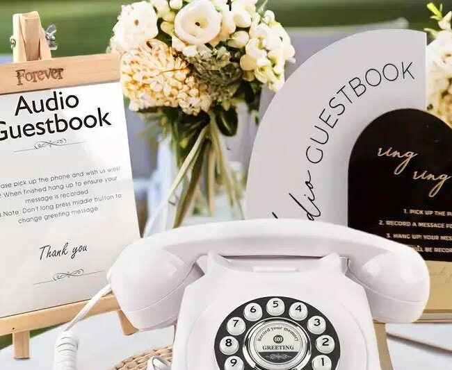 A white telephone for audio guest book services with a sign indicating what to do.